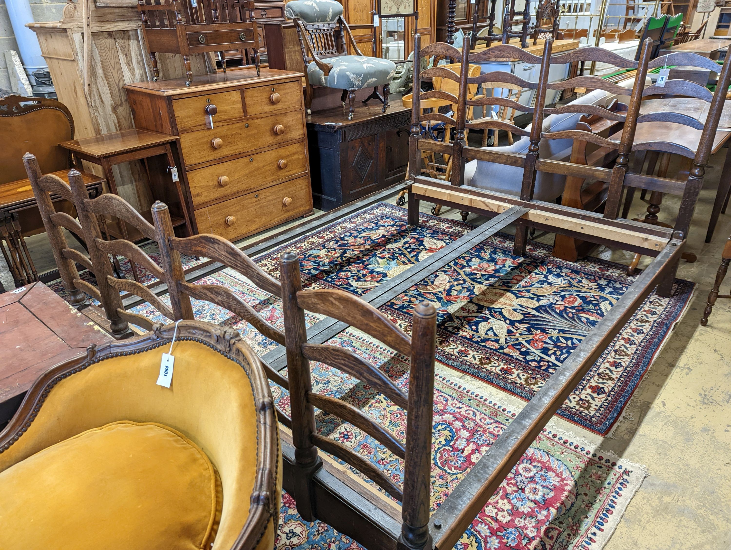 A 1920's oak ladderback double bed frame, width 157cm